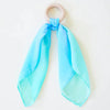 Baby holding the Sarah's Silks Sea Teether maple wood ring with flowing sea-coloured playsilk