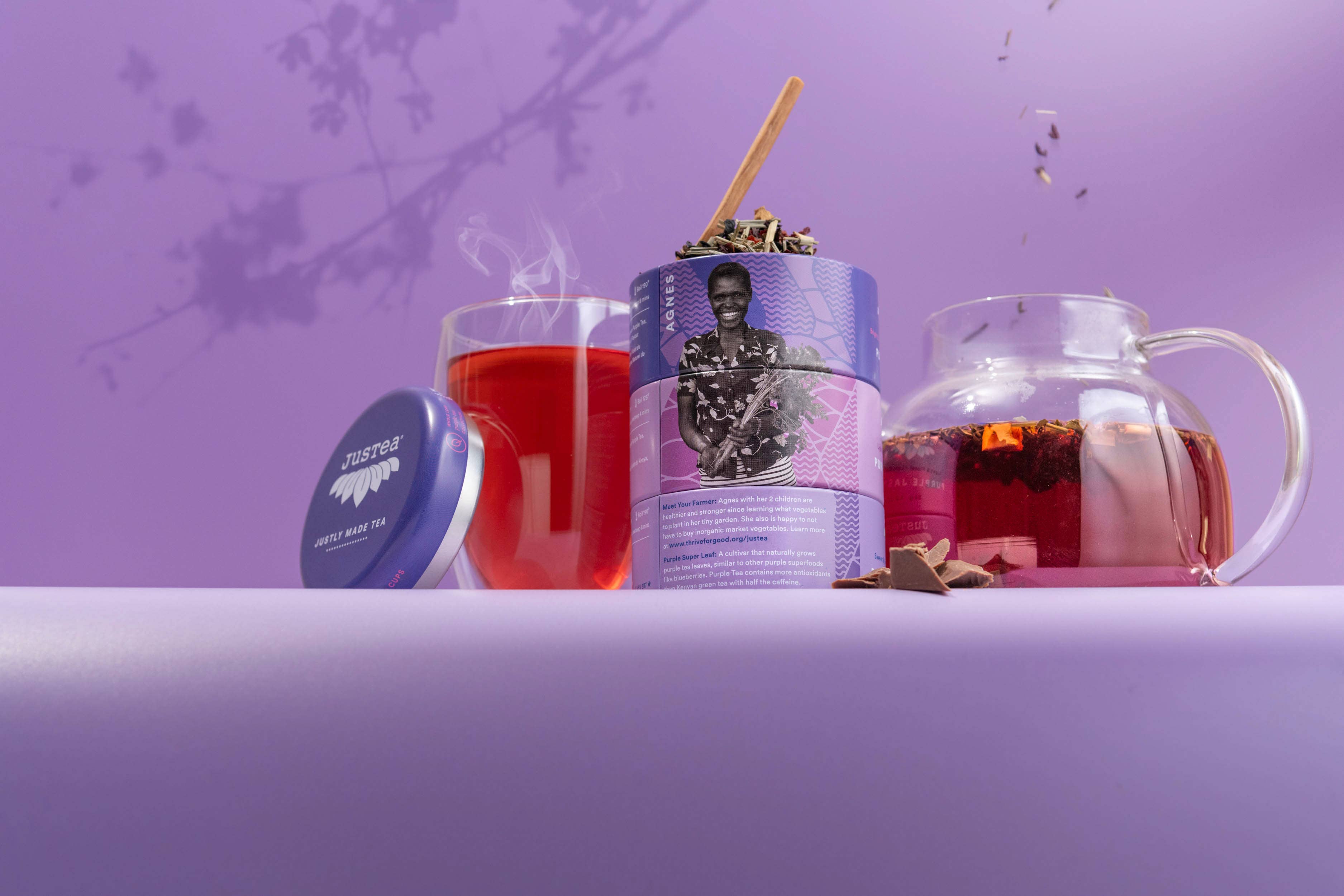 Tea packaging with a glass of tea and a teapot on a purple background