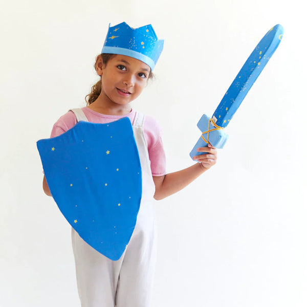 Child in princess costume with blue cape, crown, and sword on a white background
