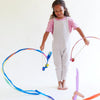 Child playing with colorful hula hoops on a white background