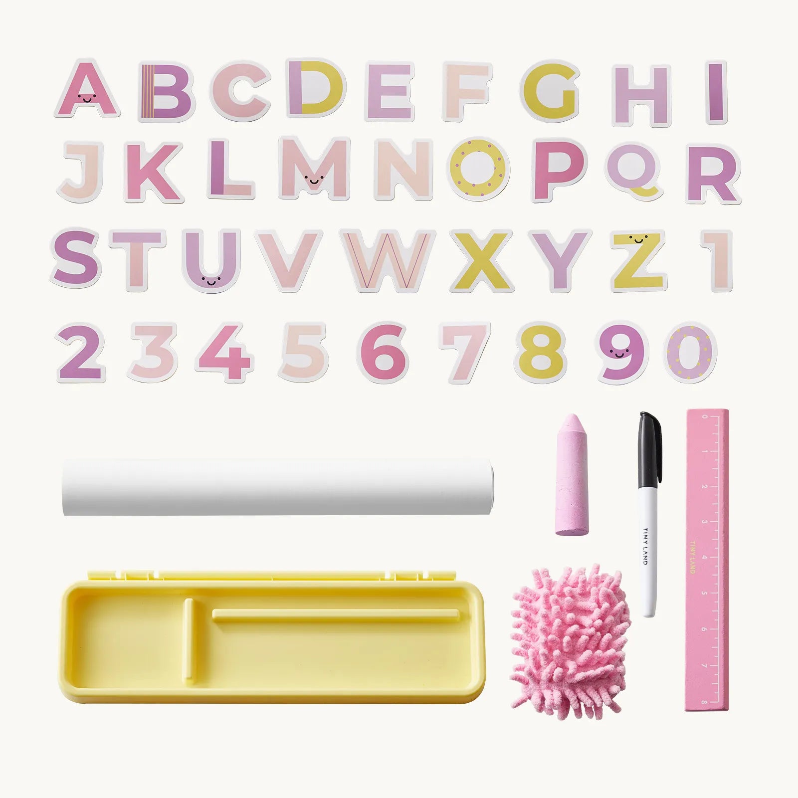 A children's alphabet and number learning set arranged on a light cream background, including pastel alphabet letters, numbers 0-9, a yellow tray, a white roll, a pink crayon, a white marker, and a pink microfiber brush.