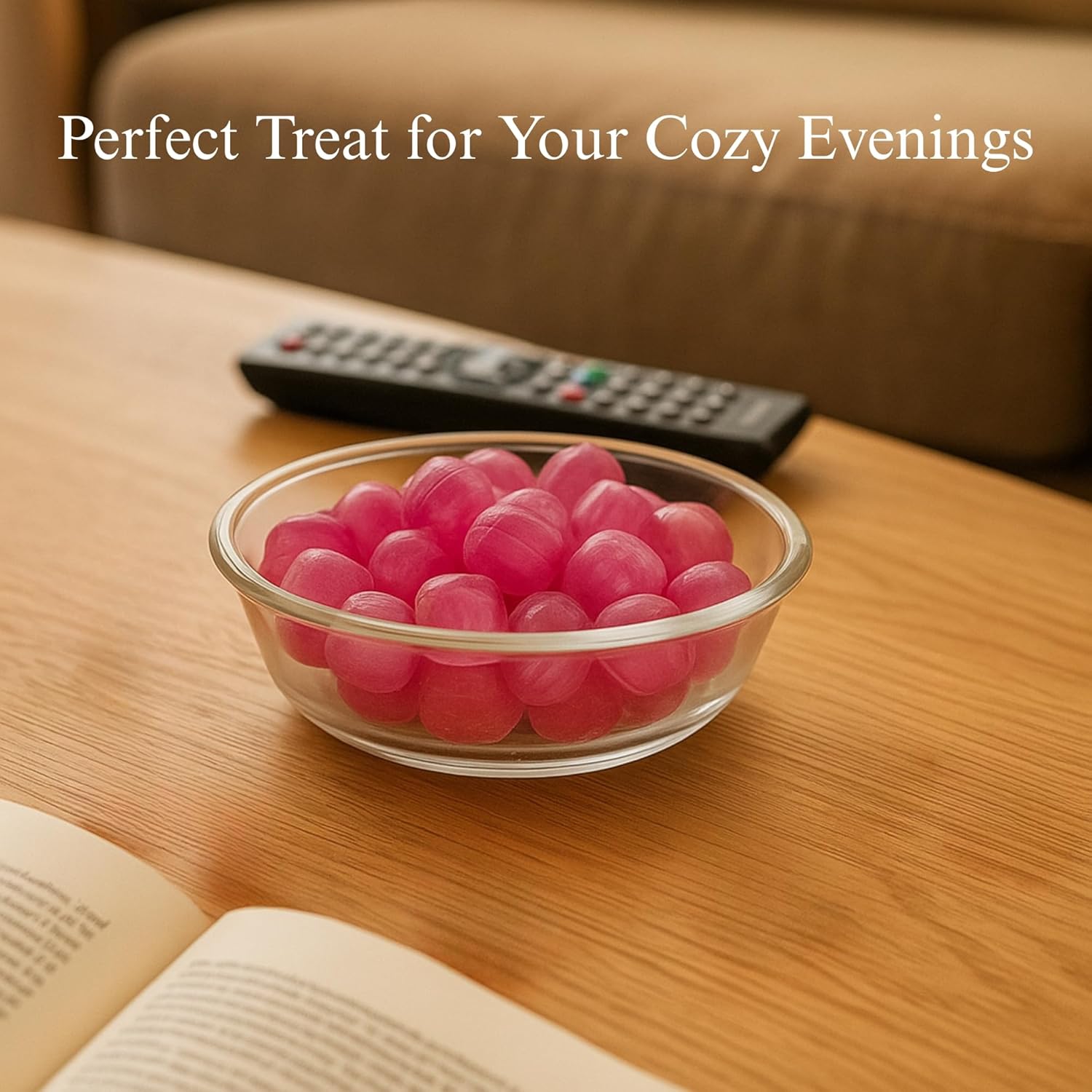 Glass bowl of pink gumballs on a wooden table with a remote control and book, text 'Perfect Treat for Your Cozy Evenings'.