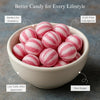 Bowl of pink and white striped candies with lifestyle benefits text on a gray background