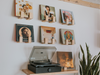 Record player with vinyl records on a wall display against a white wall.