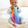 Sarah's Silks Rainbow Teether laid flat showing full rainbow silk and 3-inch Maple wood ring detail