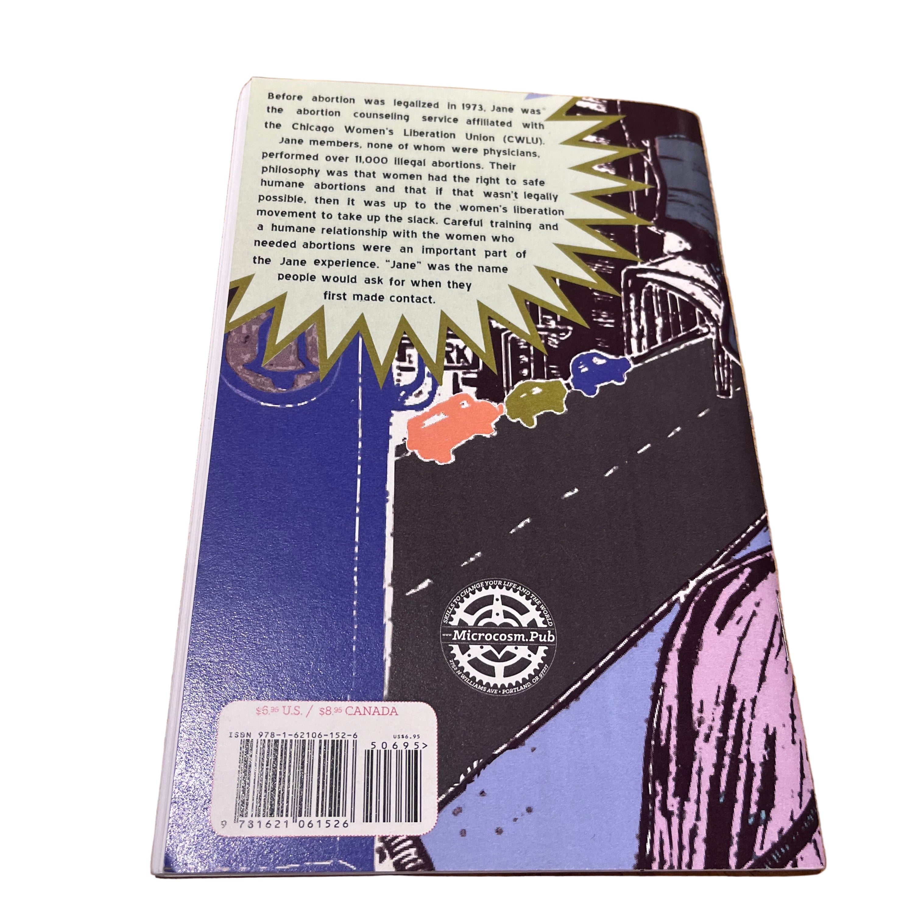 Back cover of the Jane zine showing colourful design and descriptive text about the underground abortion service, on a wooden surface