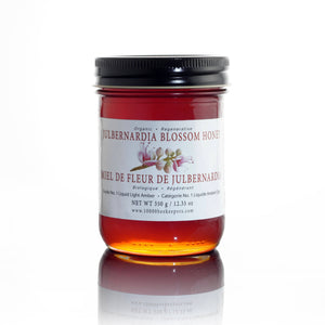Jar of Ethical Trade Co Organic Julbernardia Blossom Honey on a white background