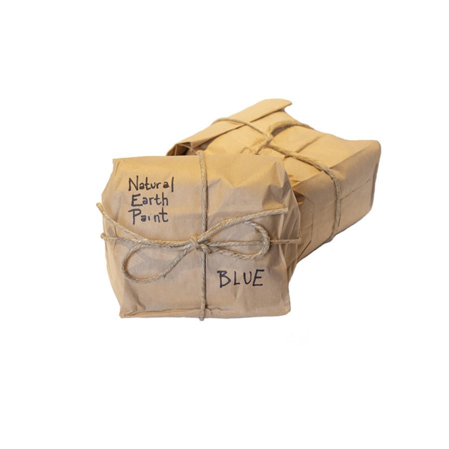 Box of Natural Earth Paint wrapped in brown paper with a string bow on a white background