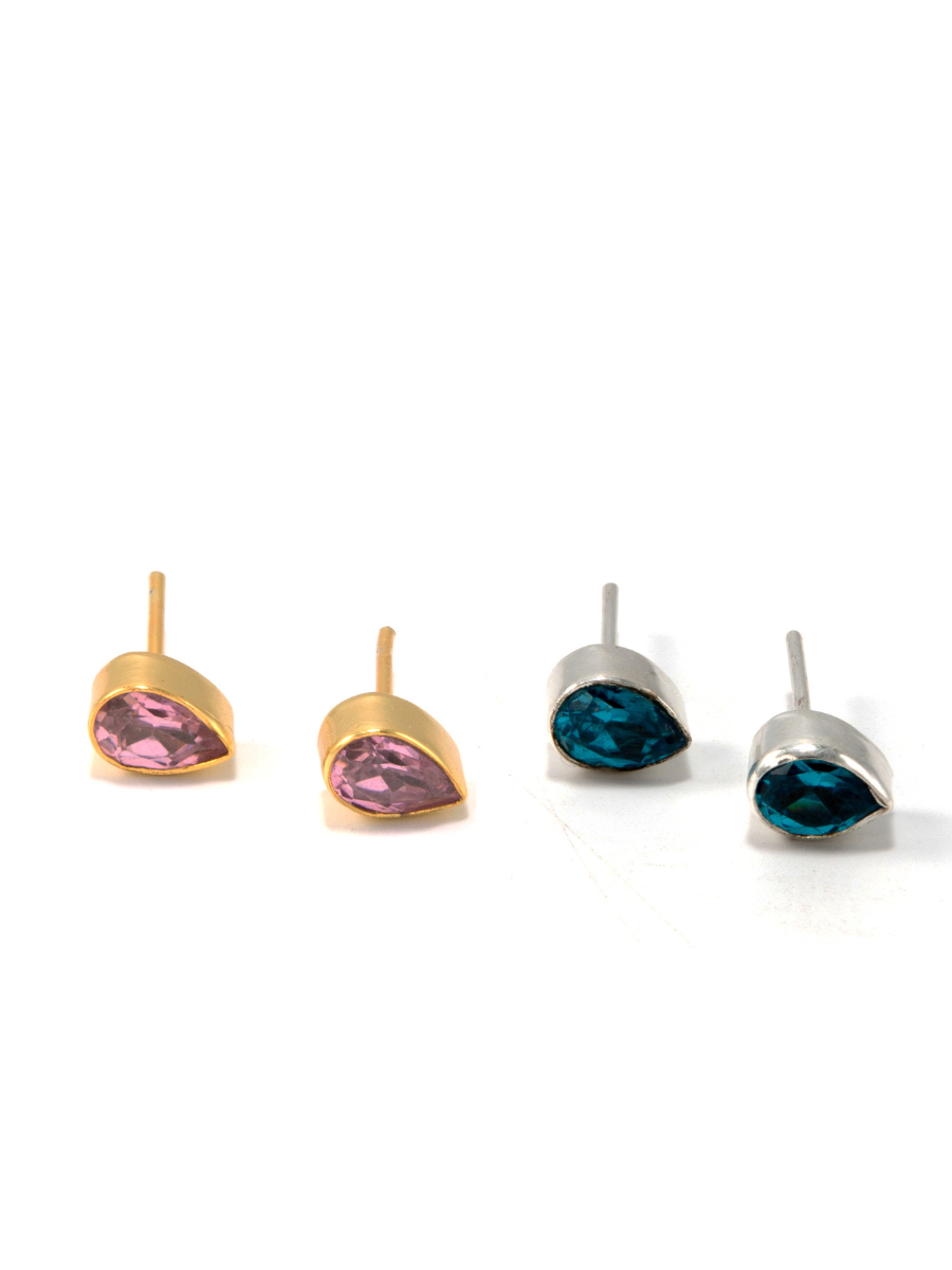 Faceted teardrop stud earrings in blue zircon and recycled silver-plated metal on white background