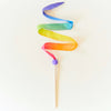 Colorful ribbon on a stick against a white background