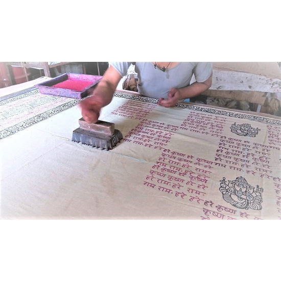 Close-up of hand block-printed black Ganapati and mantra motifs on naturally dyed red sandalwood cotton meditation shawl by OMSutra