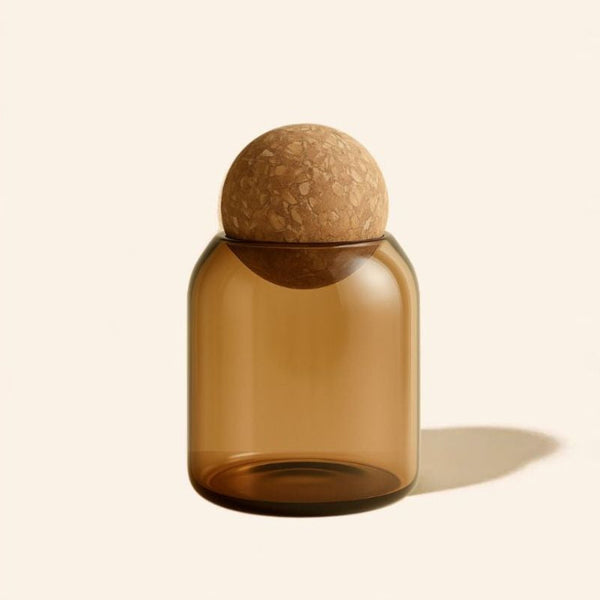 Brown glass bottle with cork stopper on a beige background
