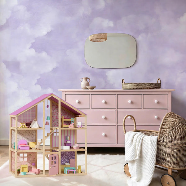 Dollhouse with furniture and accessories in a room with a pink dresser and decorative mirror.