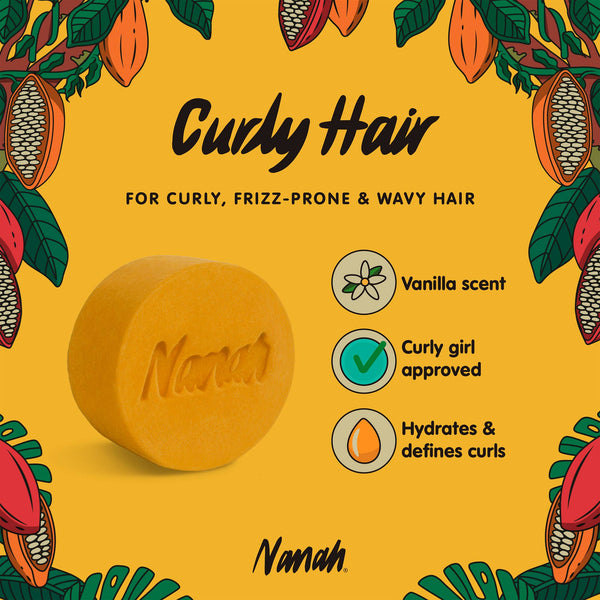 Yellow soap bar with 'Nanah' branding on a yellow background with cacao bean illustrations. Sulfate-free curly hair shampoo bar with argan oil, vegetable keratin & nopal extract — Curly Girl Method approved. Defines curls, fights frizz. Perfect curl gift.