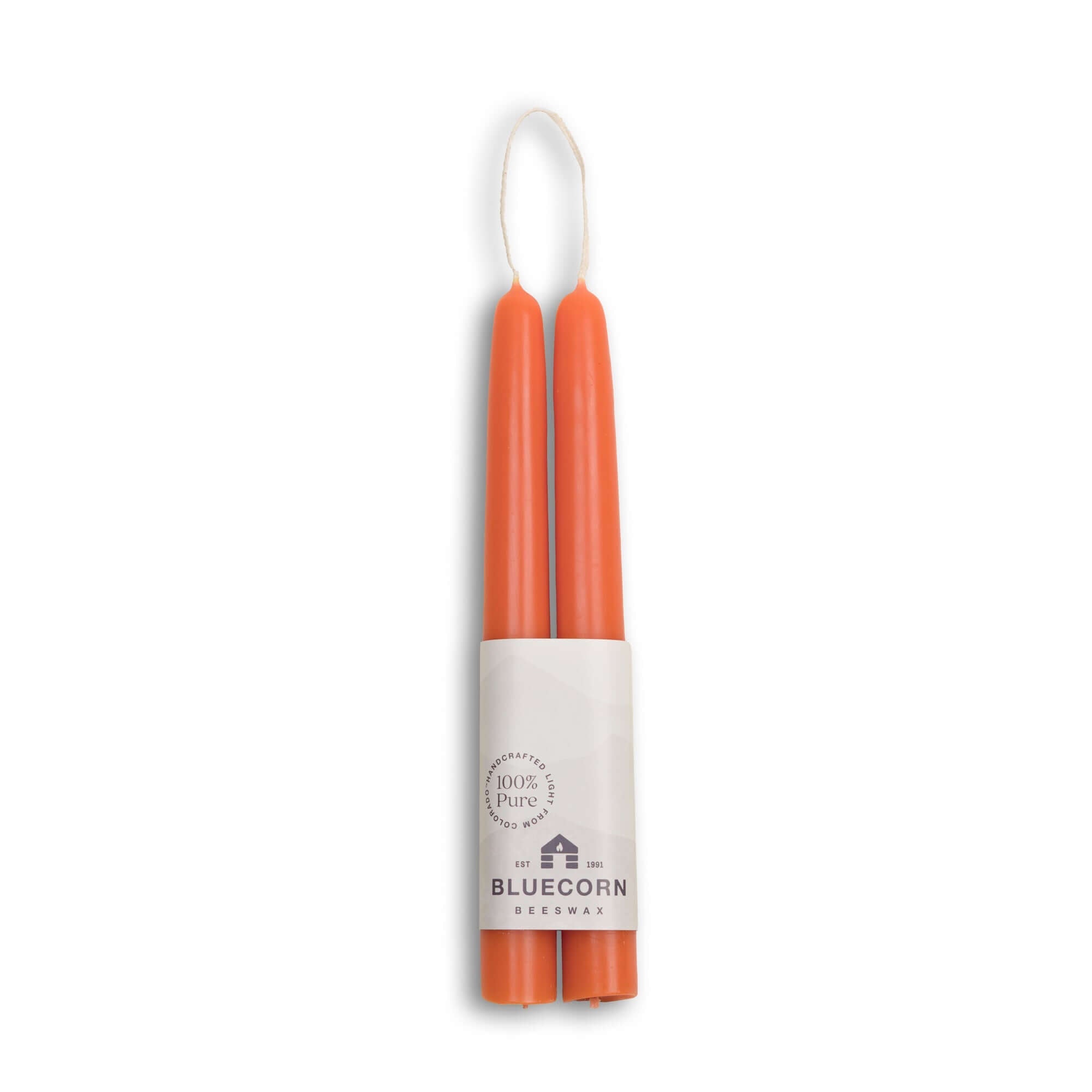 Two orange candles in a cylindrical holder with 'Bluecorn' branding on a white background