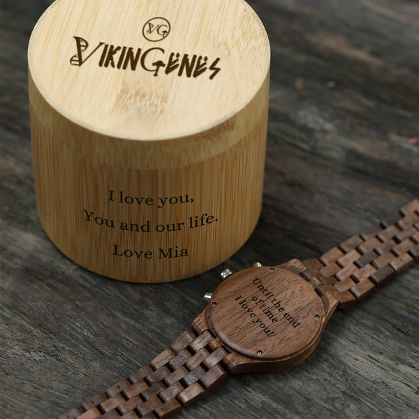 Wooden watch and decorative box with engraved text on a wooden surface