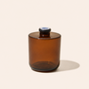 Brown glass jar with a blue cap on a beige background