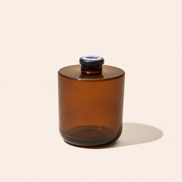Brown glass jar with a blue cap on a beige background