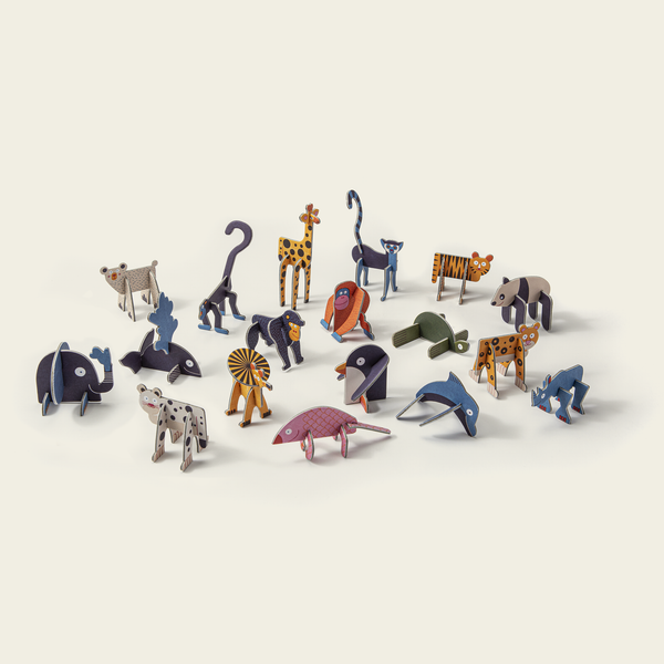 Collection of small animal figurines on a light beige background