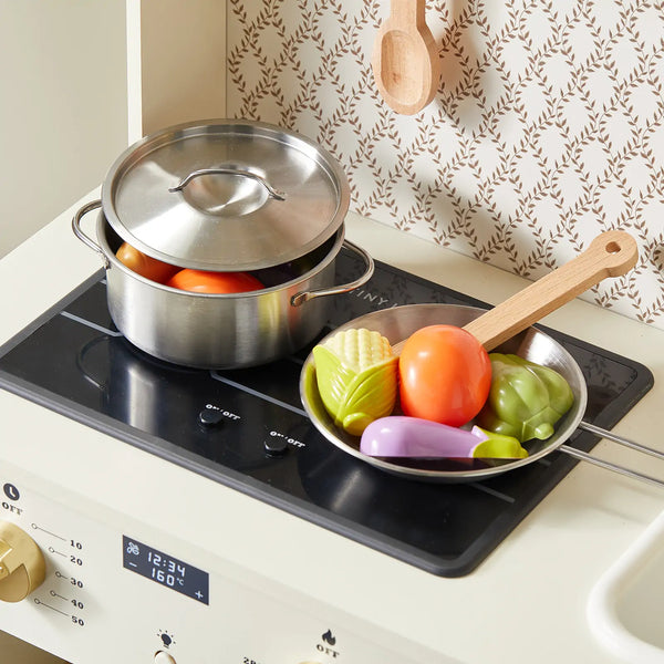 Stovetop with a pot and pan containing vegetables on a kitchen counter.
