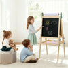 Children playing with a wooden easel in a bright room