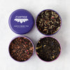 Justea tea tin with three compartments of different teas on a light background