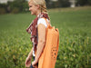 Lifestyle image of the OMSutra Chakra Rivet Yoga Mat Bag worn over the shoulder
