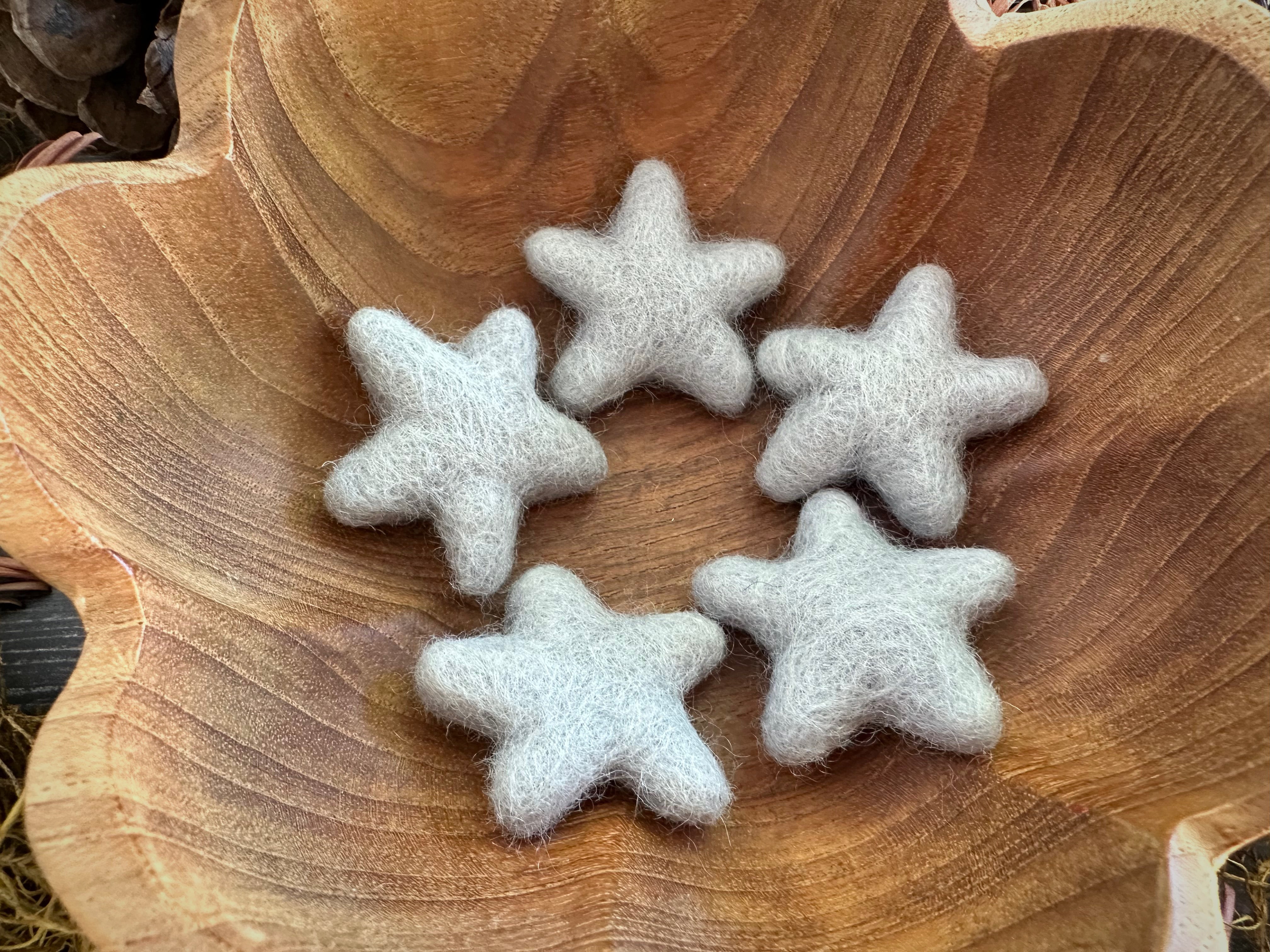 Felted wool stars in Morning Blue showing their varied shapes and sizes