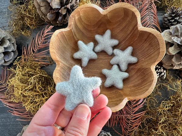 Close-up of needle-felted wool stars in Morning Blue