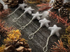 Close view of a needle-felted wool star ornament with cotton string loop