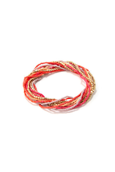 Stacked handmade glass and brass bead bracelets from the Fair Anita Celebration Elastic Bracelet Set