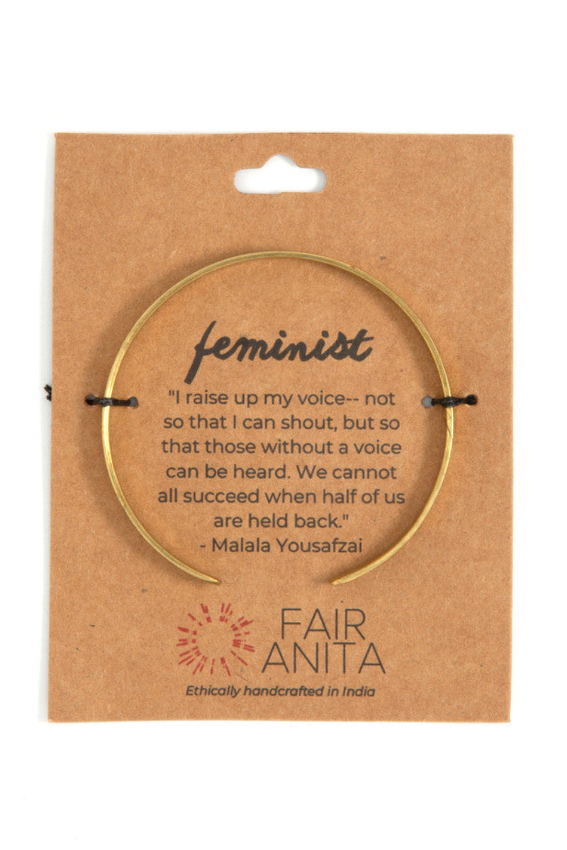 Woman wearing nickel-free feminist cuff bracelet on wrist