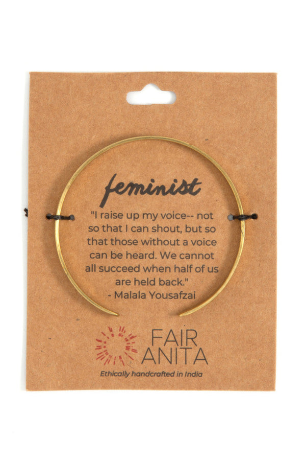 Woman wearing nickel-free feminist cuff bracelet on wrist