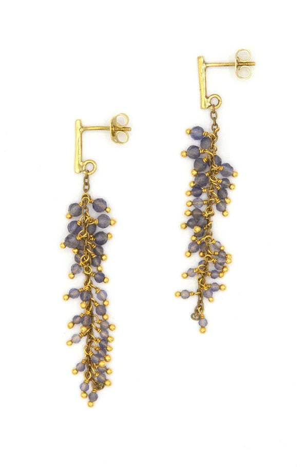 Close-up of iolite semi-precious stone cluster earrings showing violet-blue gemstone detail