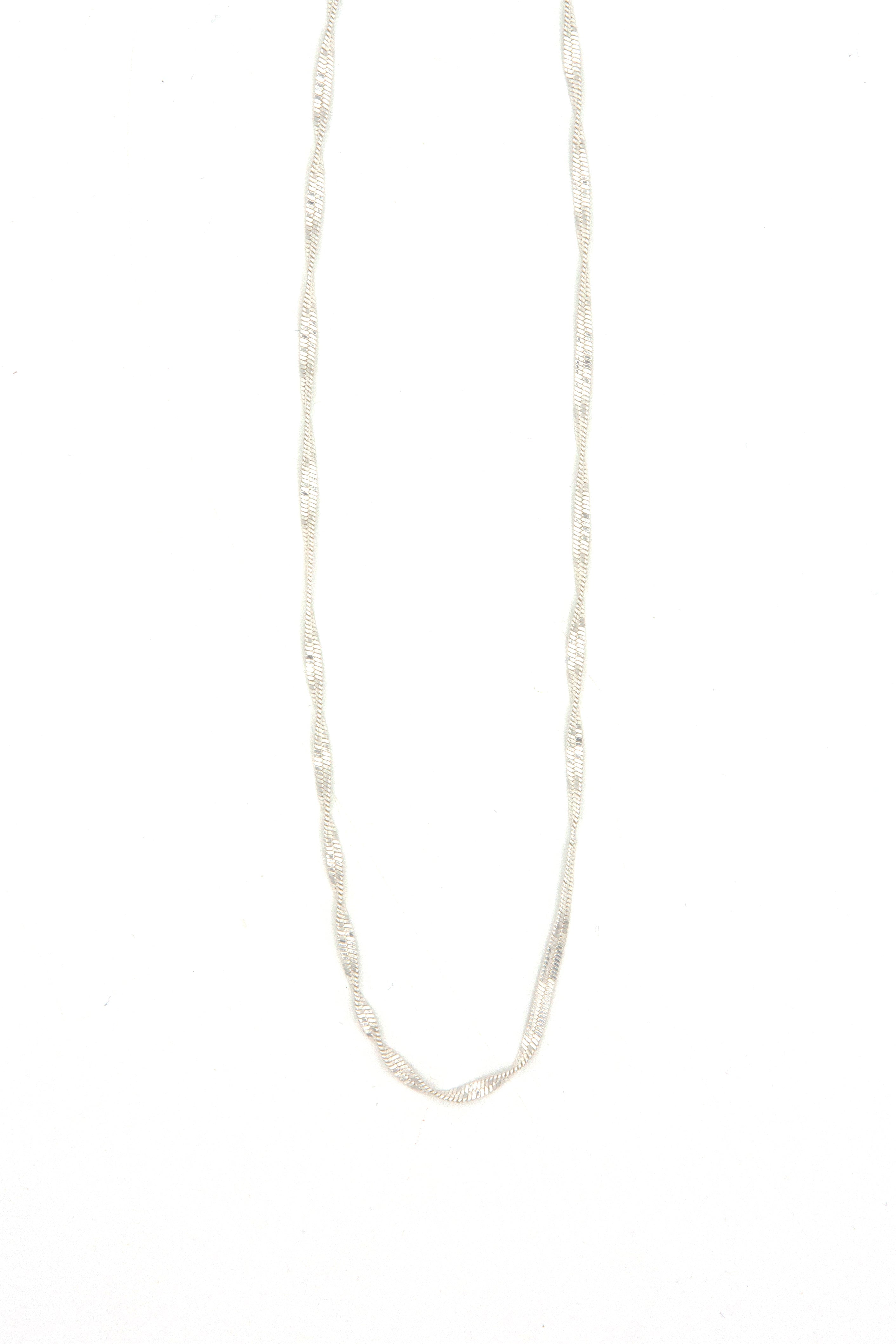 Woman wearing 19 inch twisted snake chain necklace layered with other necklaces