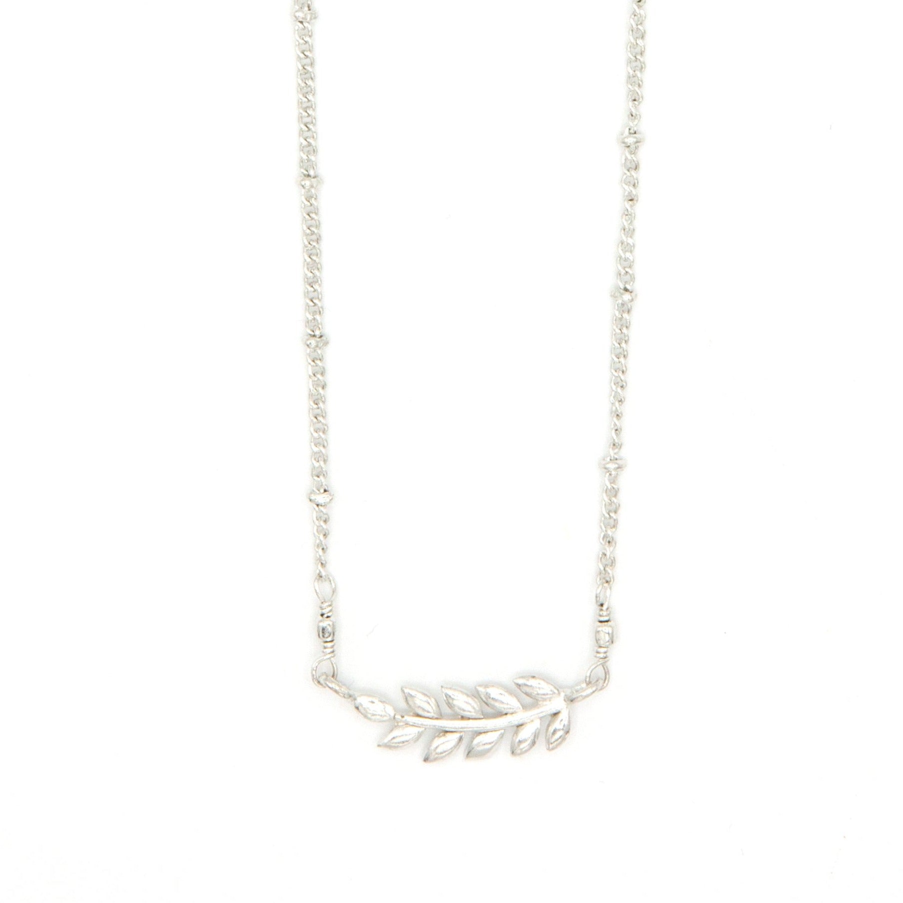 Close-up of fair trade fern necklace gold plating and chain extender