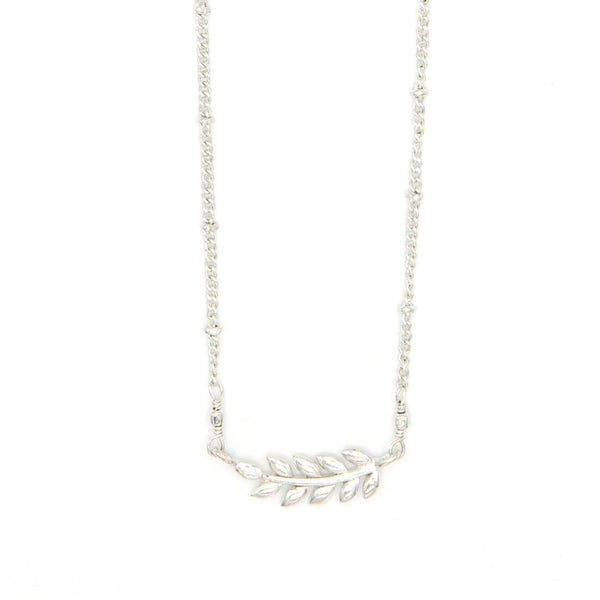 Close-up of fair trade fern necklace gold plating and chain extender