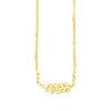 Ethically made fern necklace in recycled brass worn as a layering piece