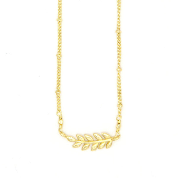 Ethically made fern necklace in recycled brass worn as a layering piece