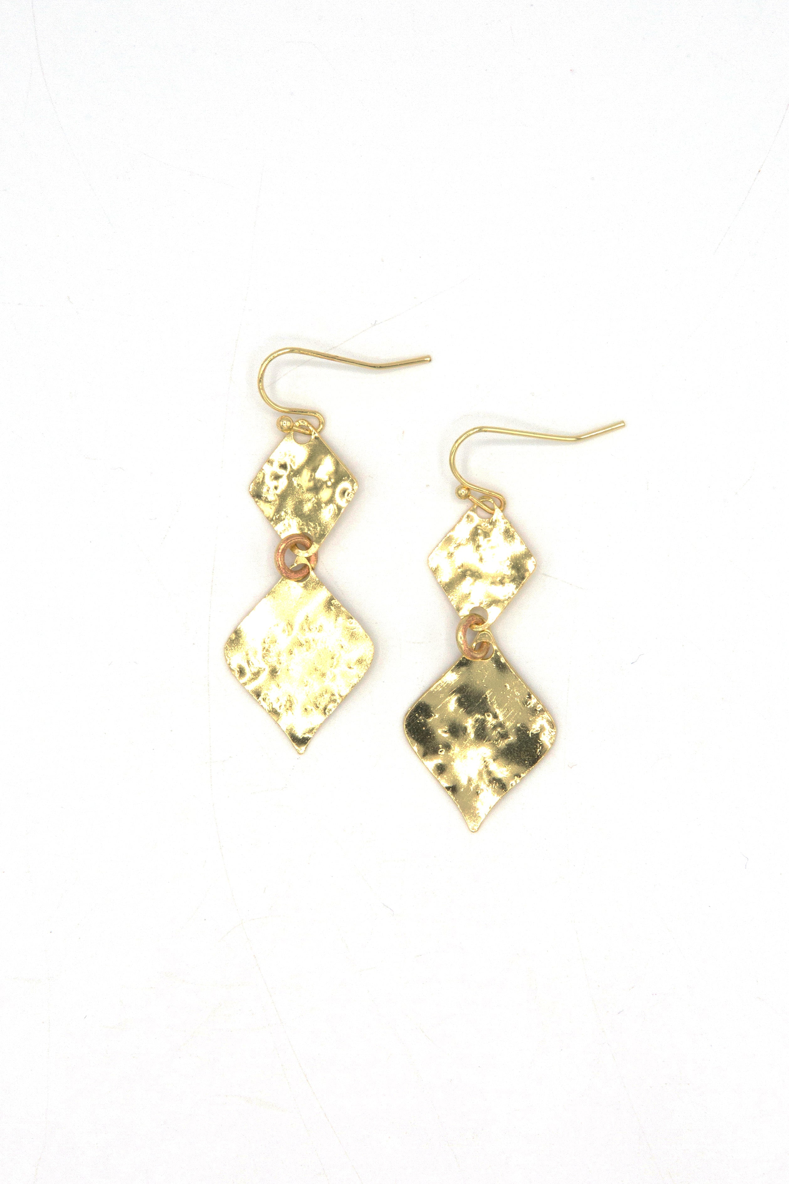 Close-up of Fair Anita hammered rhombus earrings showing textured finish