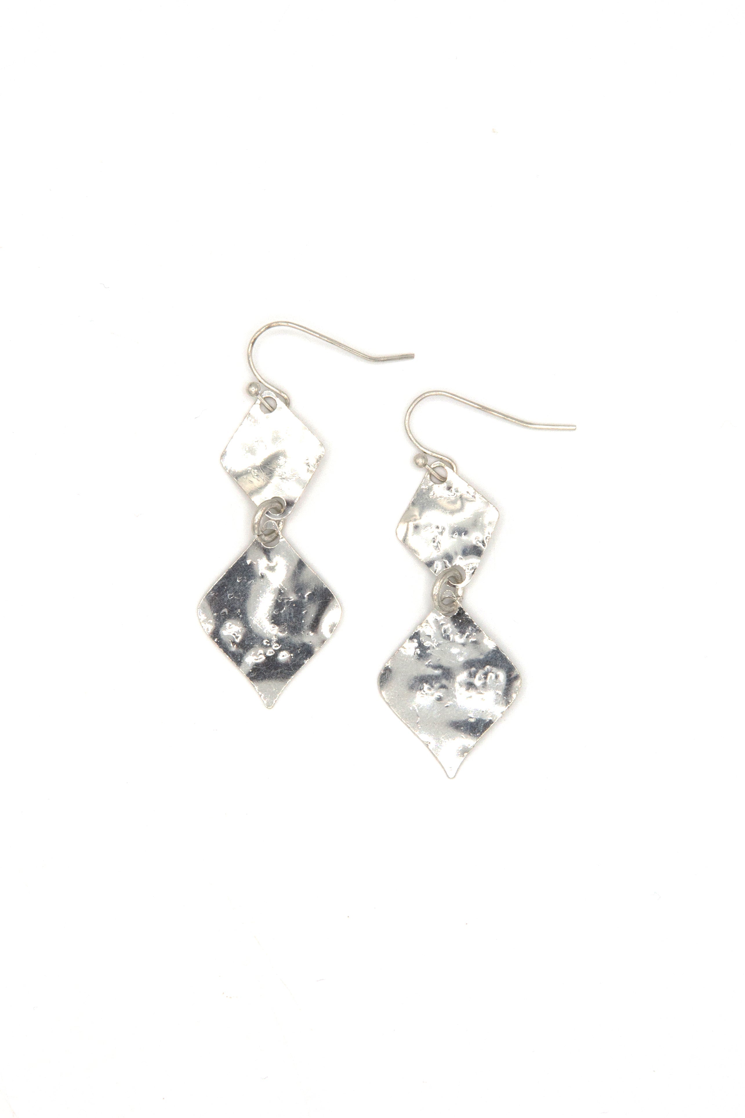 Woman wearing gold hammered rhombus earrings from Fair Anita India collection