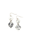 Woman wearing gold hammered rhombus earrings from Fair Anita India collection
