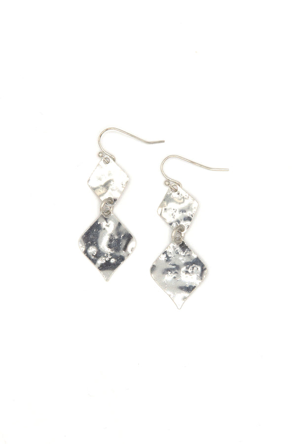 Woman wearing gold hammered rhombus earrings from Fair Anita India collection