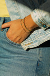 Close-up of Fair Anita Restoration Dainty Beaded Bracelet featuring ruby zoisite beads on a wrist