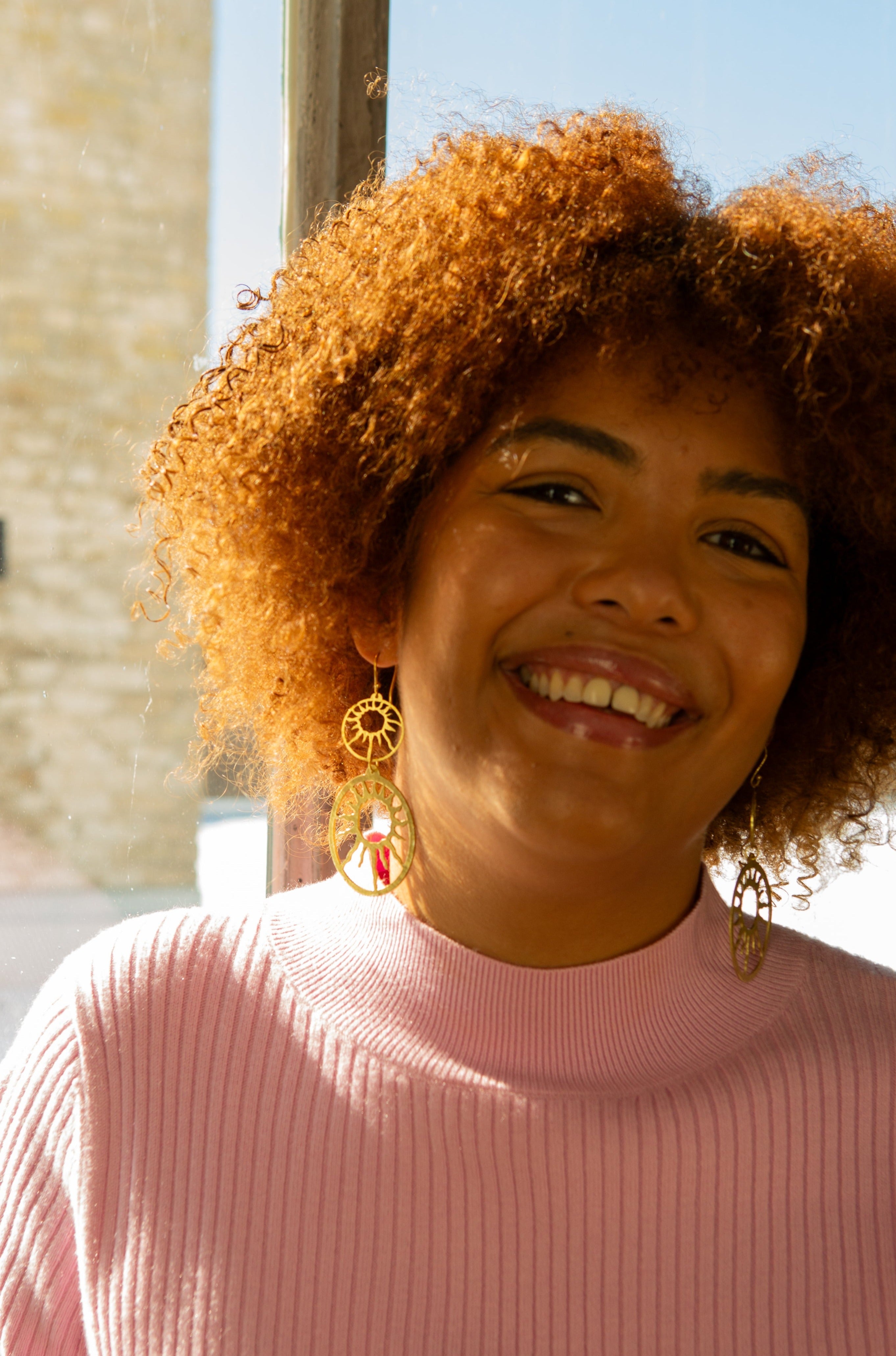 Close-up of Sol Statement Earrings showing recycled brass detail and finish