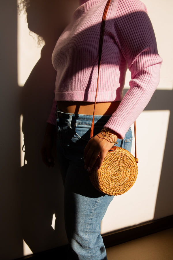 Boho rattan wicker bag styled as a crossbody, handcrafted by Fair Anita artisans
