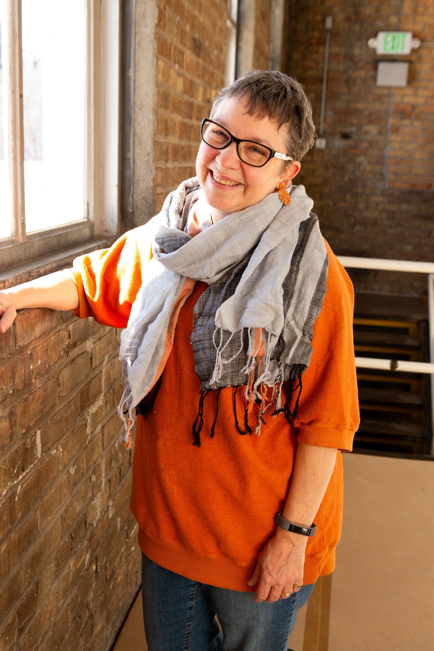 Fair Anita graphite striped scarf worn as an accessory, showcasing its generous 70-inch length and drape