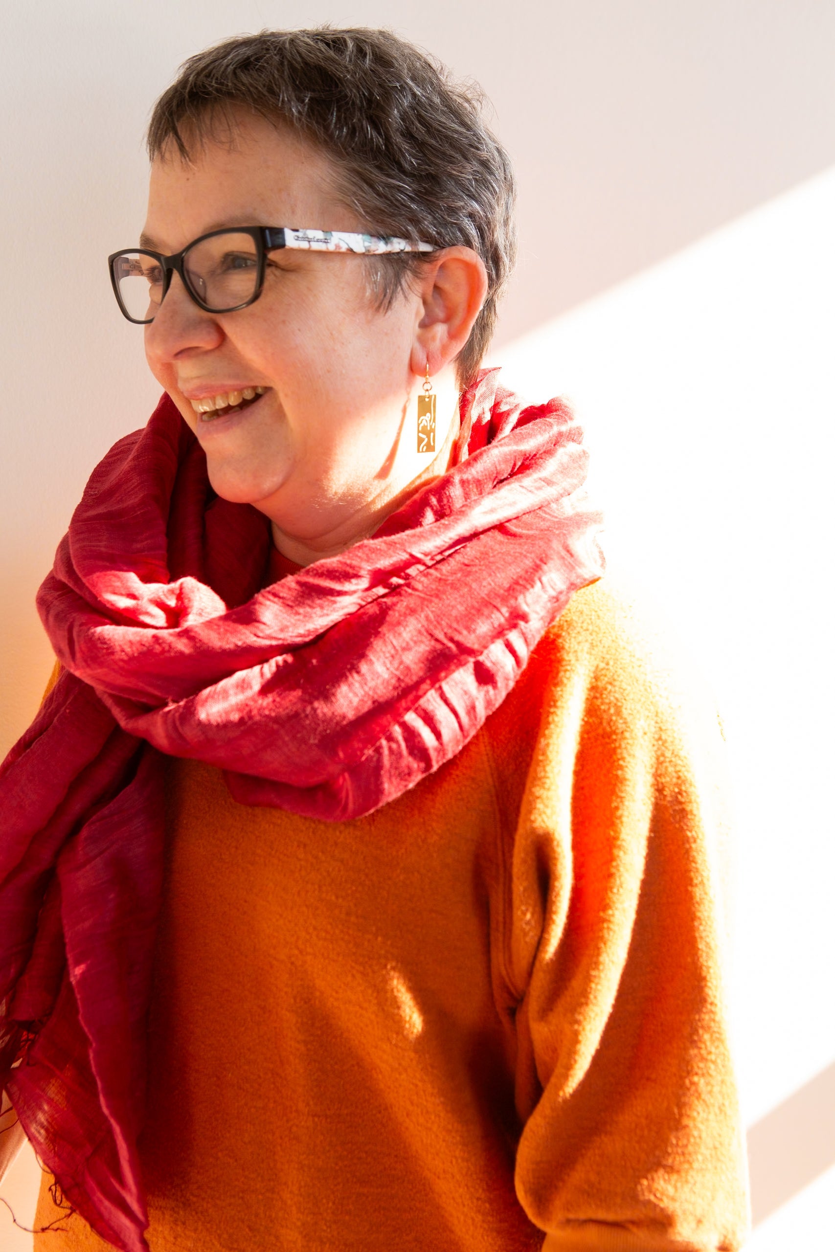 Close-up of Fair Anita red linen silk scarf showing handwoven texture and rose tones