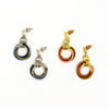 Thread Wrapped Helix Studs in gold and silver plating on model, handcrafted from recycled brass with cotton thread wrapping