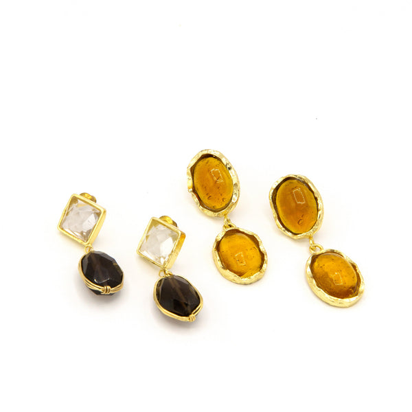 Set of gold earrings with various gemstones on a white background